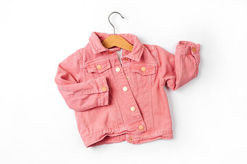 Pink jacket on hanger. Baby clothes for spring, autumn or summer on  white background. Fashion kids outfit. Flat lay, top view