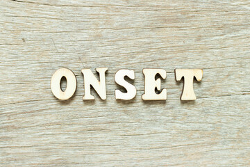 Alphabet letter in word onset on wood background