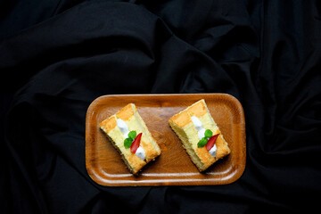 cheese chiffon cake on black background