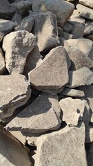 photo of a large pile of stones by the roadside used for house construction