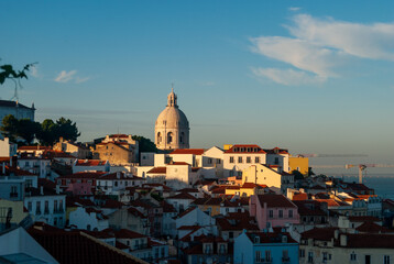 A panorama of Lisbon city at sunset buildings in the shadow golden hour last rays of sun on the National Pantheon - Lisbon, Portugal