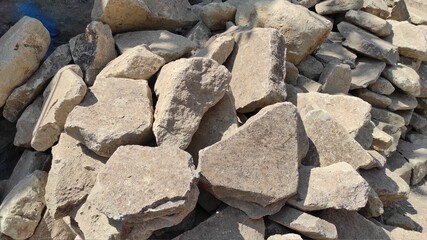 photo of a large pile of stones by the roadside used for house construction