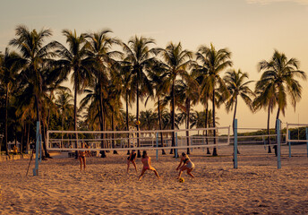 group of people on the beach playing handball women