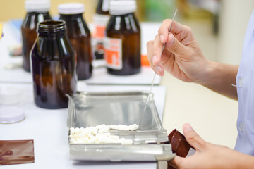Pharmacist counting pills at the pharmacy