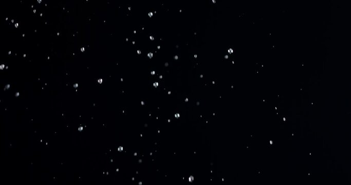 Drops of water on a black background slowly fall down. Blackmagic Ursa Pro G2, 300 fps.