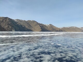 transparent lake covered with ice in winter