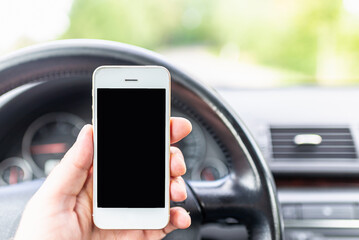 Man hand holding screen smart phone, blur on the road high way forest summer background.copy space,advertisement,banner.