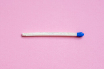 Closeup blue match on a pink background with clipping path.matchstick flat lay,copy space,selective focus.