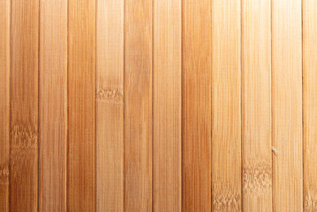 Background made of vertical yellow bamboo laths.texture, background of brown bamboo.