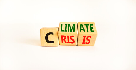 Climate crisis and change symbol. Turned wooden cubes with words 'Climate crisis'. Beautiful white background. Climate change and ecological crisis concept. Copy space.