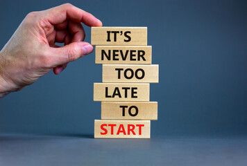 Success start symbol. Wooden blocks with words 'It is never too late to start'. Businessman hand....