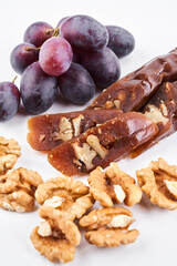 Churchkhela, national Georgian dessert made from grape juice and walnut, isolated composition on white background, copy space