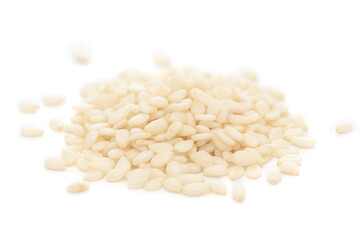 Micro close-up and details of Organic Indian White Sesame seeds(Sesamum indicum) polished or white Til without shell isolated over white background.