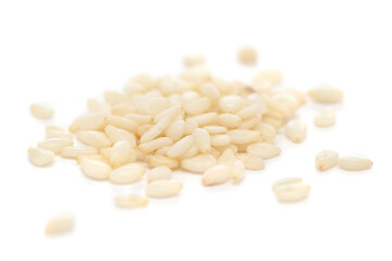 Micro close-up and details of Organic Indian White Sesame seeds(Sesamum indicum) polished or white Til without shell isolated over white background.