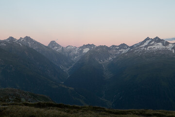 Amazing Landscape in the hearth of Canton Bernese in Switzerland. Drive on the Grimselpass. Epic scenery with the clouds and fog. Wonderful sun rays through the clouds and later an amazing sunset.