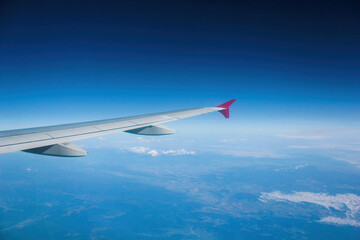 Fototapeta na wymiar airplane wing in the sky, view from airplane window