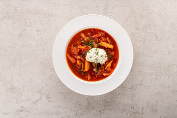 borscht with guine in a white plate