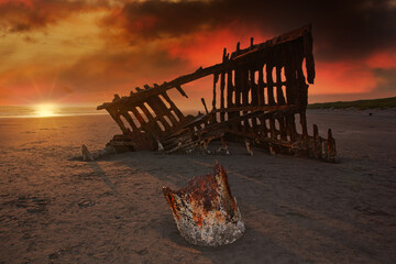 shipwreck ruins with stormy sunset as backdrop