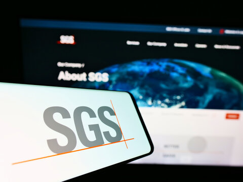 STUTTGART, GERMANY - Jun 20, 2021: Smartphone with logo of Swiss certification company SGS S.A. on screen in front of business website.