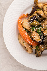 fried vegetables with chicken on a gray background