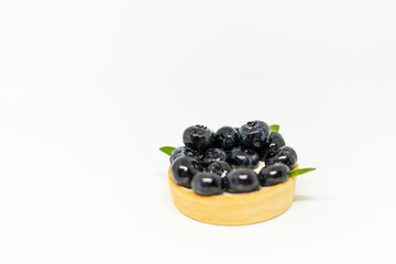 Top view of a tartlet with blueberries on a white background