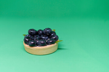 Shortbread cake with blueberries on a green background