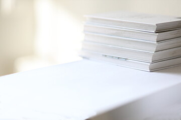 White stacked books on a shelf horizontal stock photography with copy space.