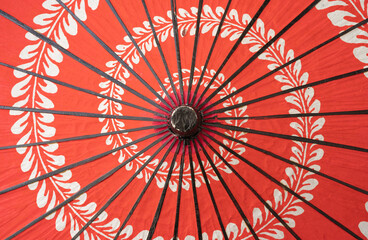 Red japanese umbrella with pattern background. Symbol of protection. Traditional and culture design.