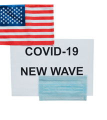 Sheet with inscription: covid -19 new wave, medical mask and U.S. flag. Isolated on a white background