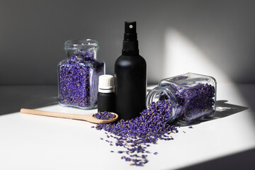 Lavender oil. Dried lavender flowers and a bottle of lavender essential oil or lavender water. 