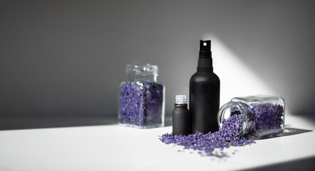 Dried lavender flowers and a bottle of lavender essential oil or lavender water. lavender oil