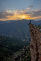Man on the top of the mountain during sunset