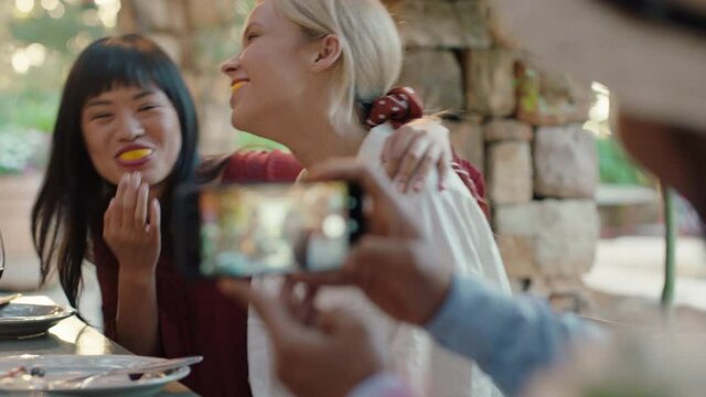 two funny woman eating oranges posing for photo making faces having fun with friends laughing enjoying summer reunion outdoors happy tourist people on vacation 4k