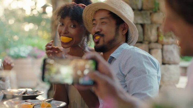 funny couple eating oranges posing for photo making faces having fun with friends laughing enjoying summer reunion outdoors happy tourist people on vacation 4k