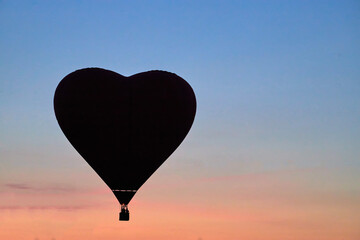 The silhouette of ballons on sky background.