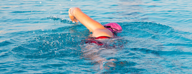 Rear view of a swimmer swimming in a pool