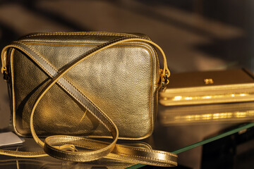 Women's handbag made of artificial leather of gold color.