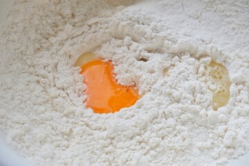 Eggs in the bowl of flour