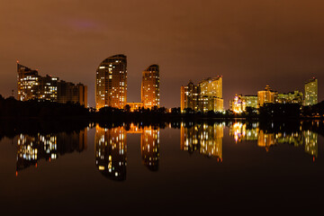 night city with reflection of houses in the river