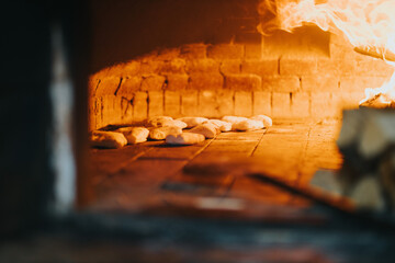Selective focus of doughs baking in the masonry oven of a restaurant
