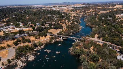 Daytime aerial view of the American River and the city of Folsom, California, USA.