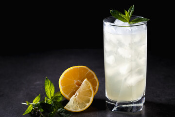 reshly squeezed lemonade with mint in a tall glass with ice.