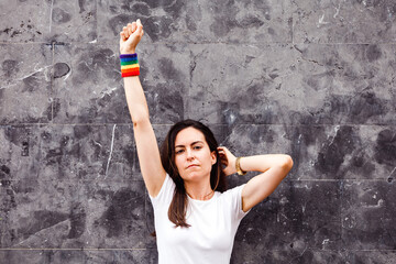 Lesbian with rainbow armband and high fist. Proud concept. LGBT power.