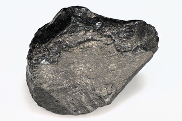 Black piece of coal on a white background close up isolated