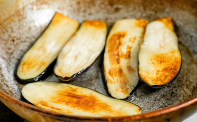 Eggplants are fried in a pan