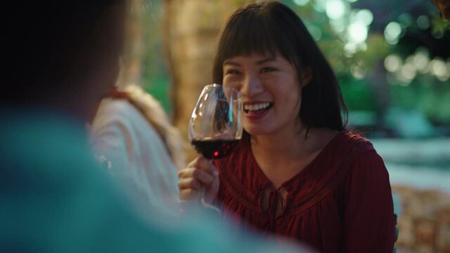 beautiful asian woman enjoying dinner date flirting with man couple drinking wine making toast celebrating romantic evening together 4k