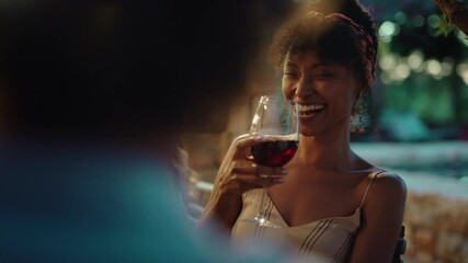 beautiful african american woman enjoying dinner date flirting with man couple drinking wine making toast celebrating romantic evening together 4k - Powered by Adobe