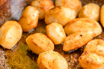 Whole fried potatoes in oil