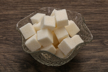 Refined white sugar cubs in the bowl