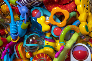 Children's toys on a multi-colored background. Toys for baby and newborn.